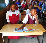 Provide desks to students in Malawi